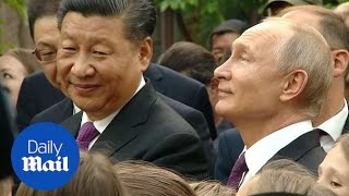 Putin and Xi admire pandas in Moscow zoo