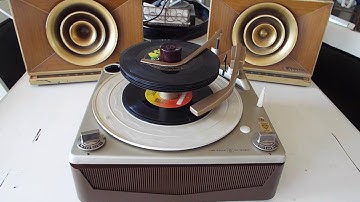 Motorola Calypso record player playing a stack of 45 RPM, 7" records.