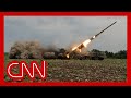 Soldiers take rocket launcher out of hiding and fire at Russians