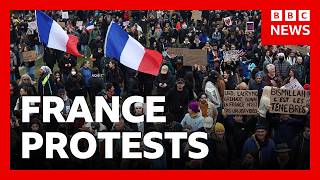 French police arrest 135 people, as tens of thousands protest across country | BBC News
