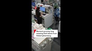 Moment grocery-bag wearing thief steals from Hobart pharmacy