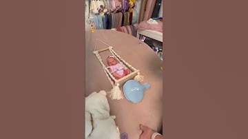 Baby on a swing behind the scenes #newbornposing #babyphotography #newbornphotography