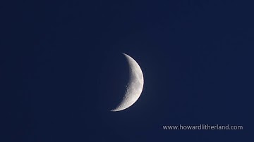 Time lapse of crescent moon traversing a dark blue sky