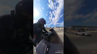 Passenger Cop Waves Back at Motorbike Rider