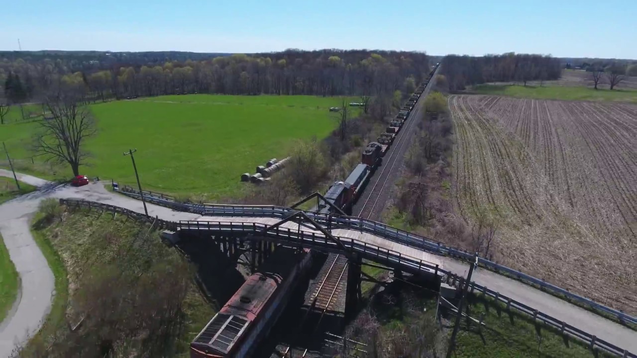 Mixed freight train, Lobo Siding ON, CN 2560 / 4612 / 2927 / 230 / 7200 [drone] (2017-Apr-23)