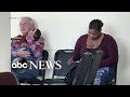 Grandfather cradles stranger's baby in waiting room