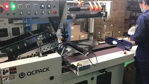 Irregular plastic object shrink wrapping machine with automatic feeding system.