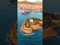 Vertical video. Kusadasi, Turkey. Scenic aerial view of Pigeon Island and its castle at sunset. T...