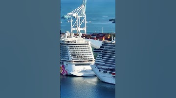 In a row: Norwegian Joy cruise ship stern and MSC Seascape cruise ship bow