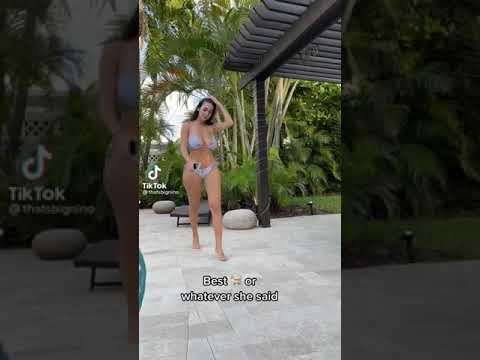 Busty full figure lady in bikini takes a stroll by the pool
