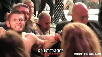 KHABIB SCREAMS AS IRISH FANS CAGESIDE GO CRAZY! RESTRAINED AFTER JUMPING DANIS!