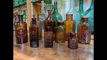 SOME AMBER ANTIQUE SKULL & CROSSBONES POISON BOTTLES