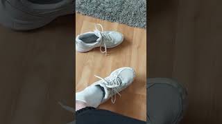 Girl takes off white sneakers and sweaty white socks after school to show feet