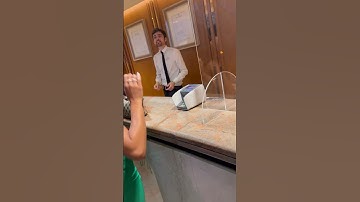 Guy Compliments Woman At Front Desk Of Hotel Check In