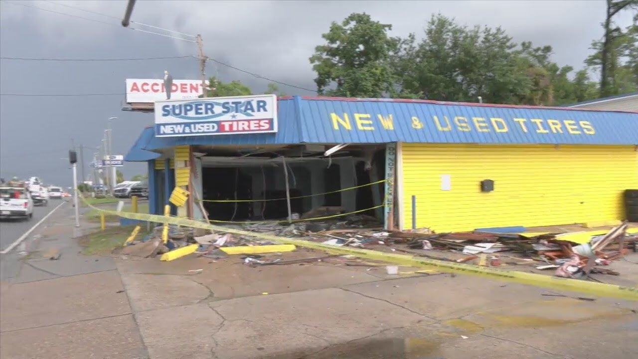 Driver injured after car crashes into business - YouTube