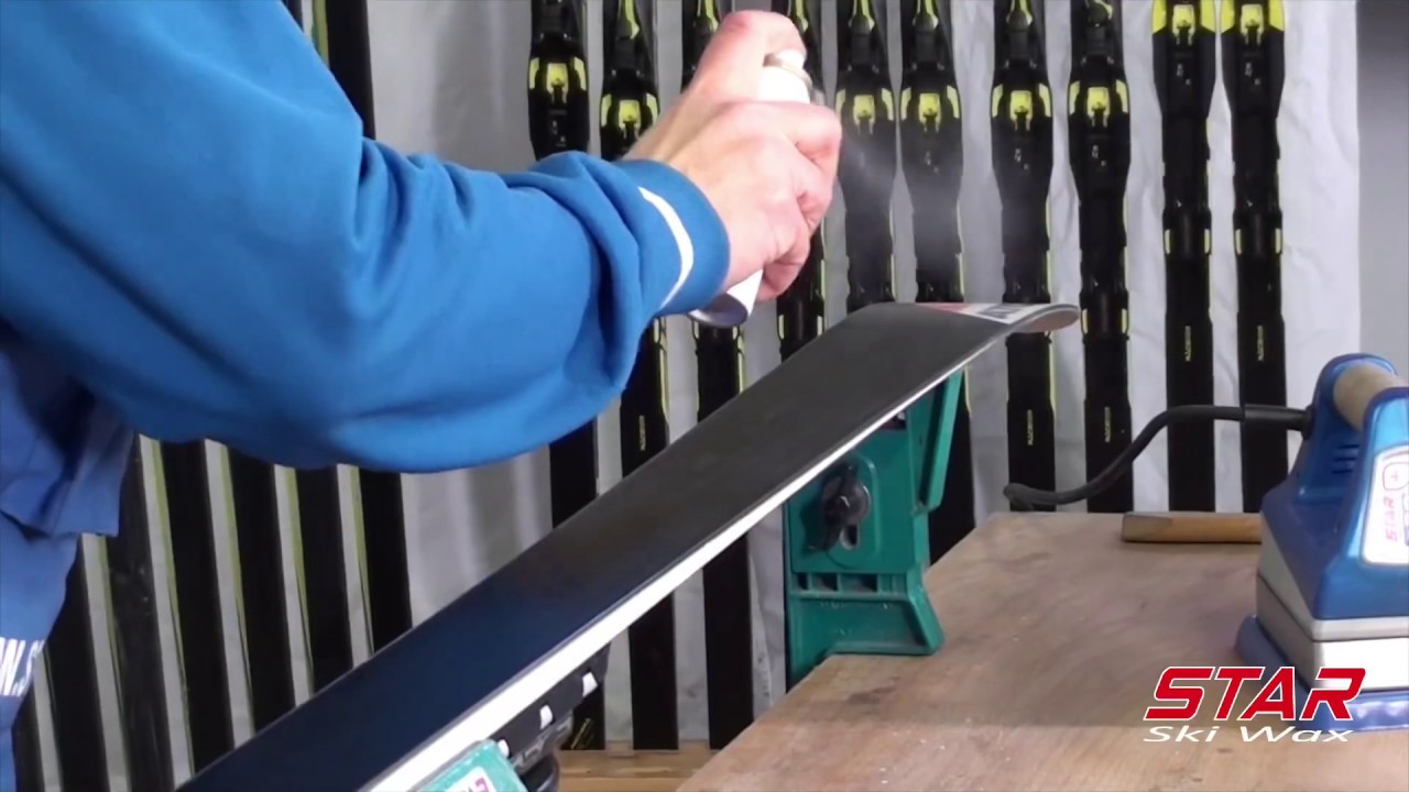 Application with cork buffer of  Liquid glide wax on Alpine ski