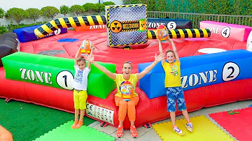 Mom helps Vlad and Niki find toys on the inflatable slides