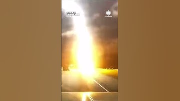 Thumbnail of BANG! Lightning Explodes Pavement, Strikes Road Next to Driver