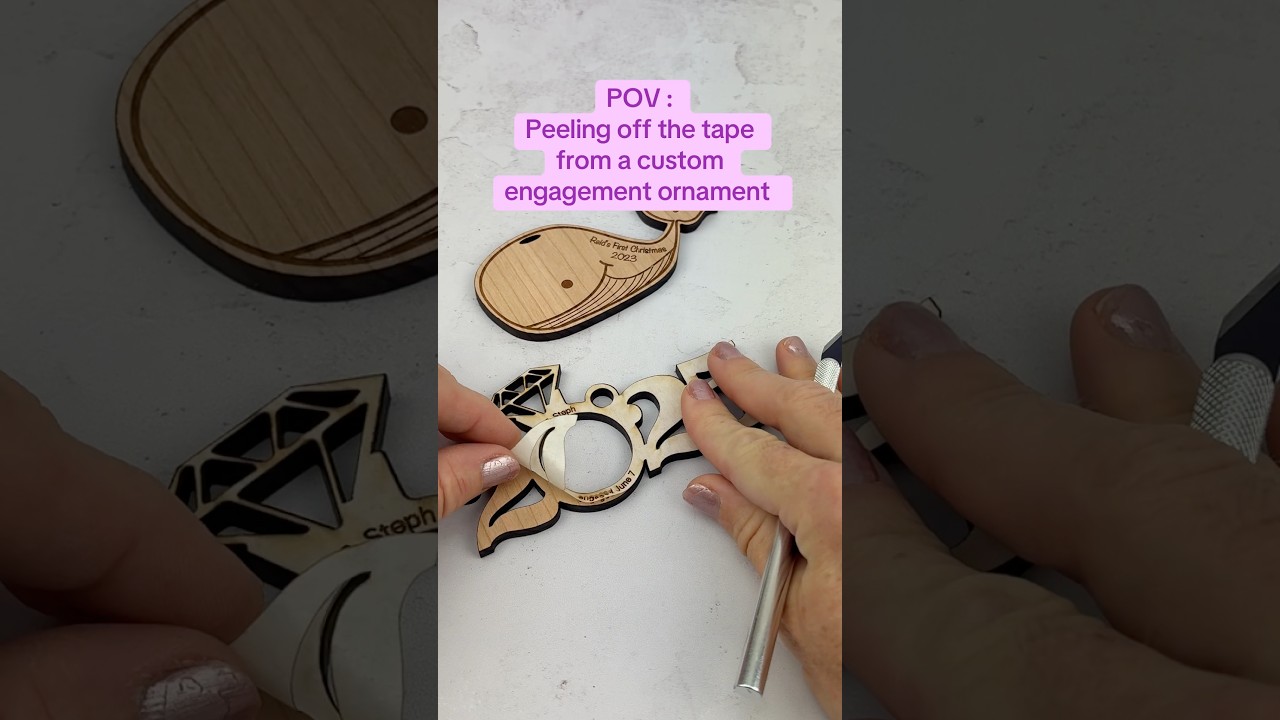 peeling off the tape on our custom engagement holiday ornaments #satisfyingvideo