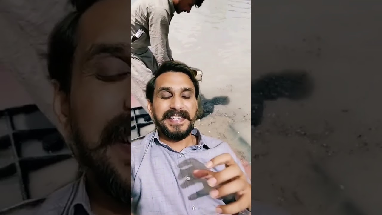 Pakitani Boy tries to drain water in Dubai after raining flood 