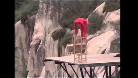 Balancing artist Eskil Ronningsbakken hangs over ravine edge