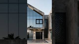 This modern duplex features a sharp, angular design with large glass windows and textured concrete.