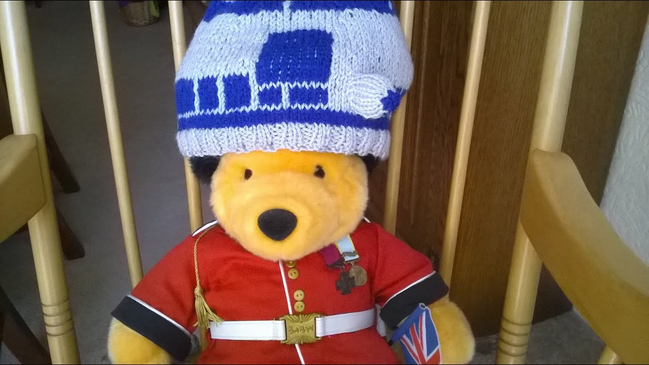Redcoat Pooh Bear wearing a knitted R2-D2 hat