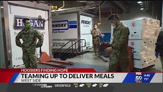 Volunteers load thousands of boxes of food on trucks to be distributed across the state
