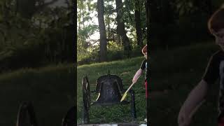 Child ringing a old cast iron bell
