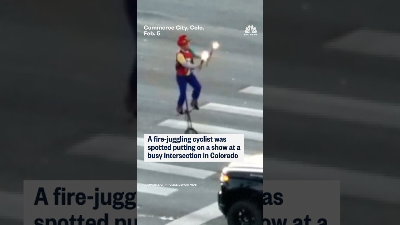 A fire-juggling cyclist was spotted putting on a show at a busy intersection in Colorado