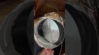 How does a manual damper on a duct work and look?