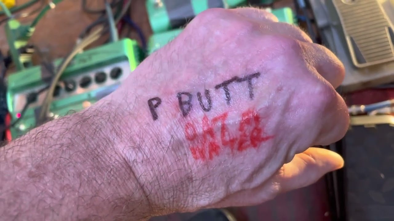 BLACK PUS PULLS BACK THE CURTAIN TO REVEAL THE PUPPETEER