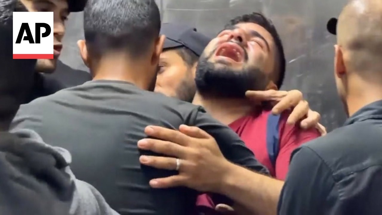 Relatives mourn after an Israeli strike hits a vehicle in Gaza, killing 2