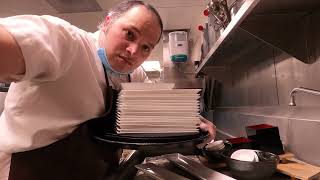 THE DISHWASHER HAS LOTS OF HOT CLEAN PLATES TO STOCK IN RESTAURANT KITCHEN MINIMUM WAGE WORK #56