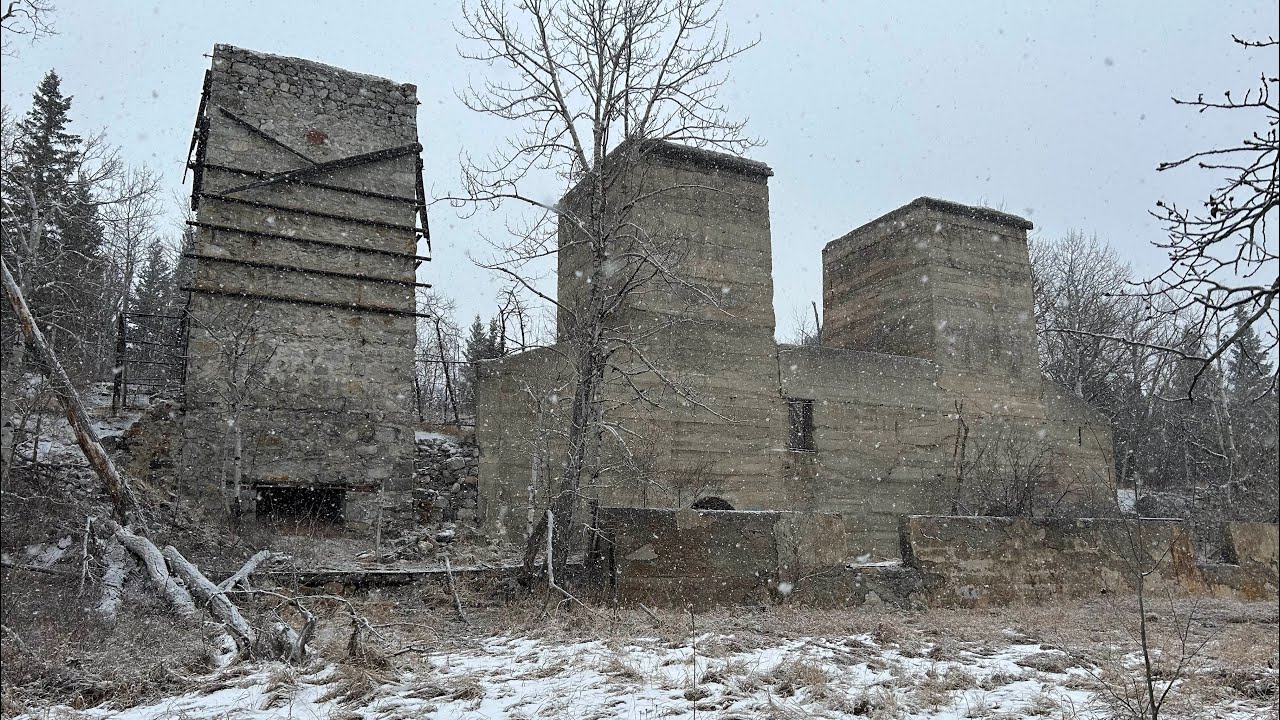 Lime City Lime Kiln ruins with old cart sit in the forests of Crowsnest Pass, Alberta. 