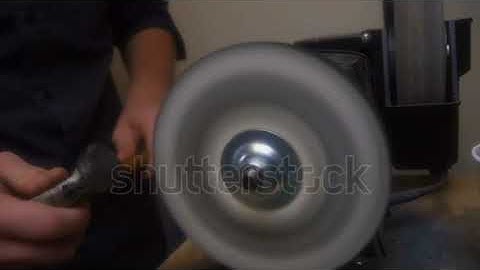 Man sharpens a tool for work close up