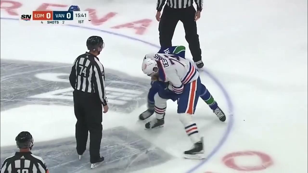 Vincent Desharnais of the Edmonton Oilers fights Dakota Joshua of the