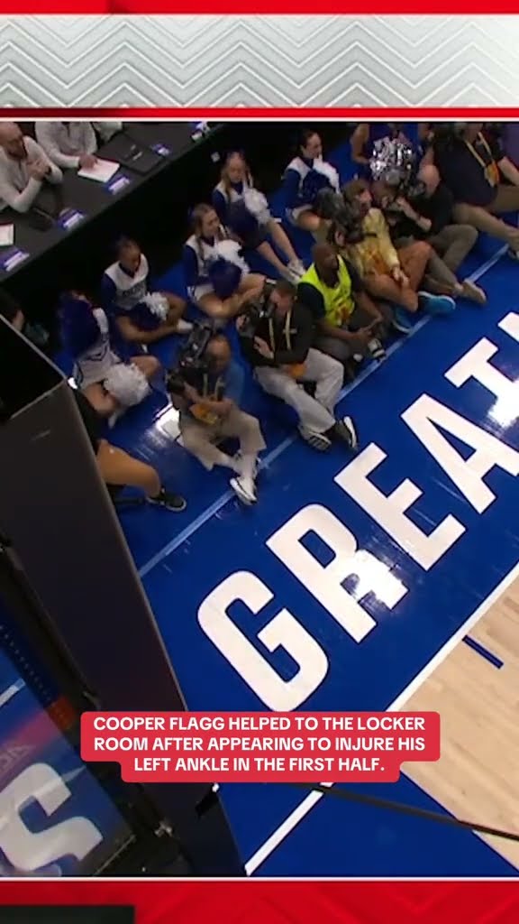 Cooper Flagg helped to the locker room after appearing to injure his ankle