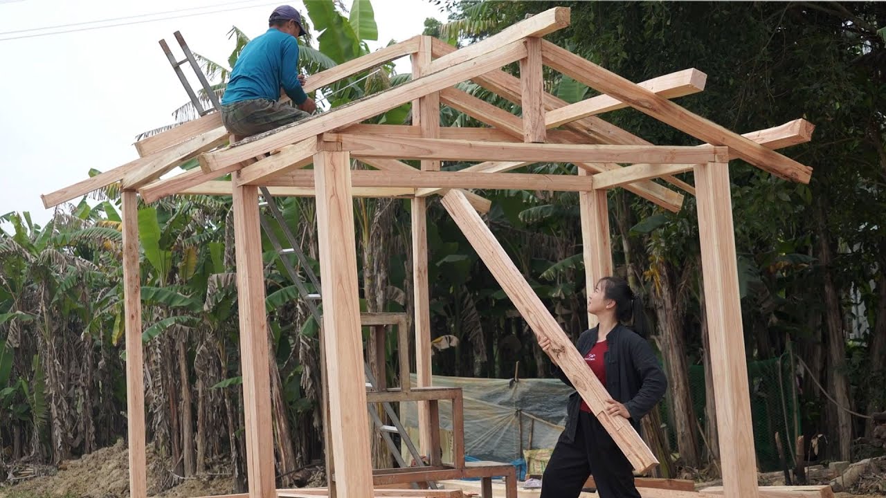 Добрый папа помогает дочери построить огромный бревенчатый дом