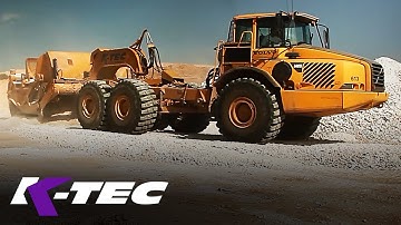 K-tec 1233ADT Scraper Unloading Gypsum Rock with Volvo ADT