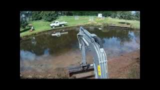 VOLVO EC15B cleaning pond edge