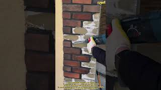 Dismantling the clinker brick layer on a building pillar using an electric hammer dril