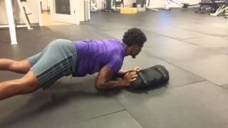 Low plank sandbag push pull