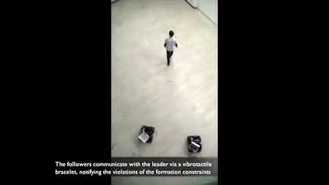 Human-robot formation control via visual and vibrotactile haptic feedback