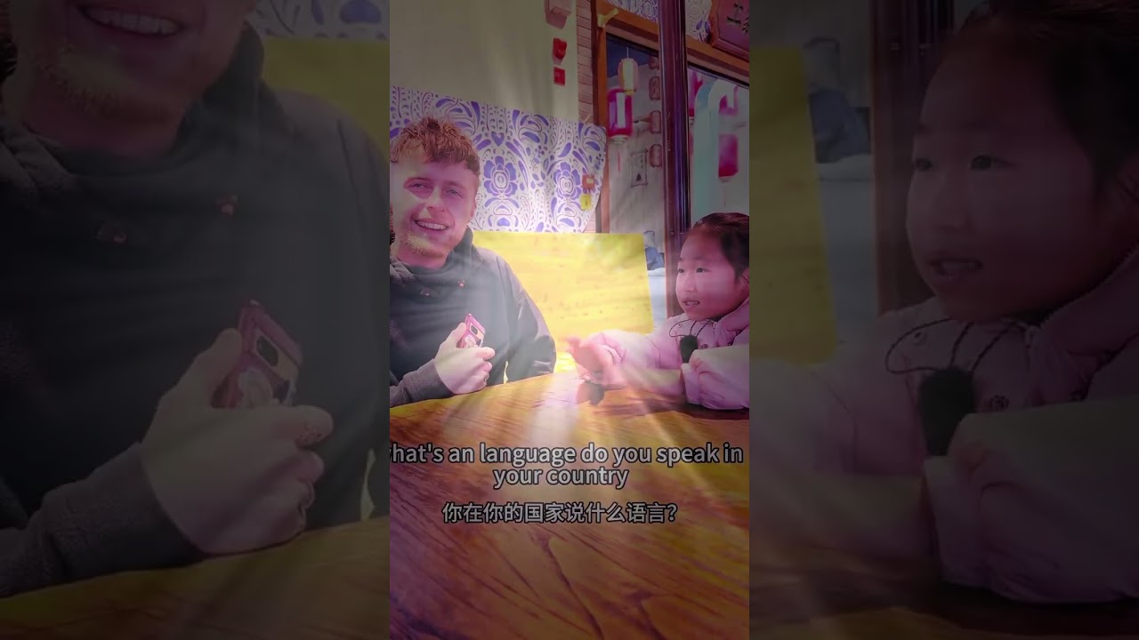 An 8-year-old Angel chats with some British and Korean tourists at a scenic spot in 