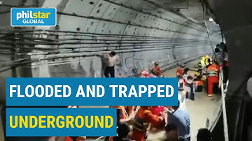 Firefighters rescue trapped passengers from flooded subway in China