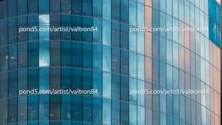 Beautiful time lapse of the cloudy sky reflected in the Windows of a skyscraper