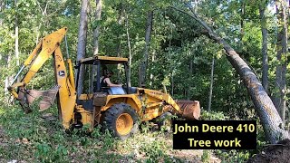 John Deere Backhoe clearing trees