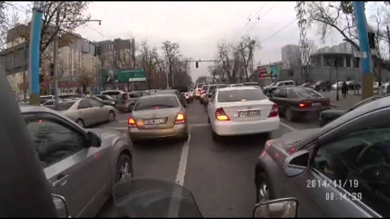 Traffic, dead traffic lights, and happy biker