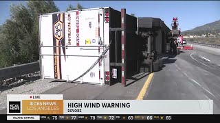 Strong winds cause semi to tip over on the 215 Freeway